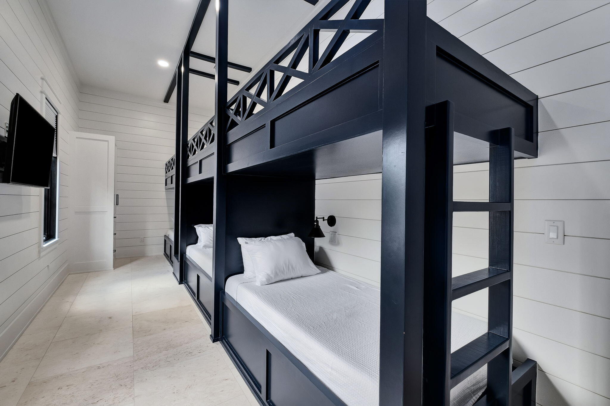 7570 East County Highway 30A Watersound, FL 32461 - Photo 31 of 64 a bedroom with a large bed and a flat screen tv