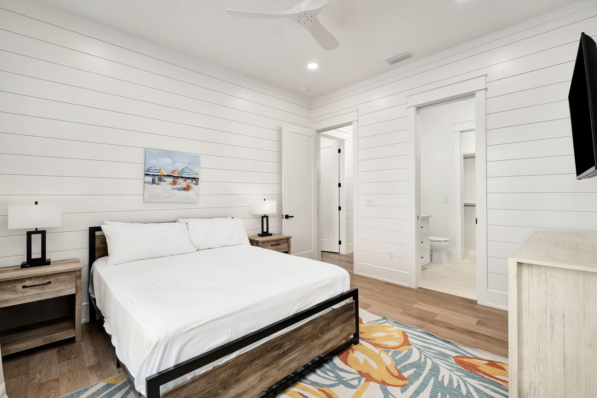 7570 East County Highway 30A Watersound, FL 32461 - Photo 33 of 64 a spacious bedroom with a bed and a table in it