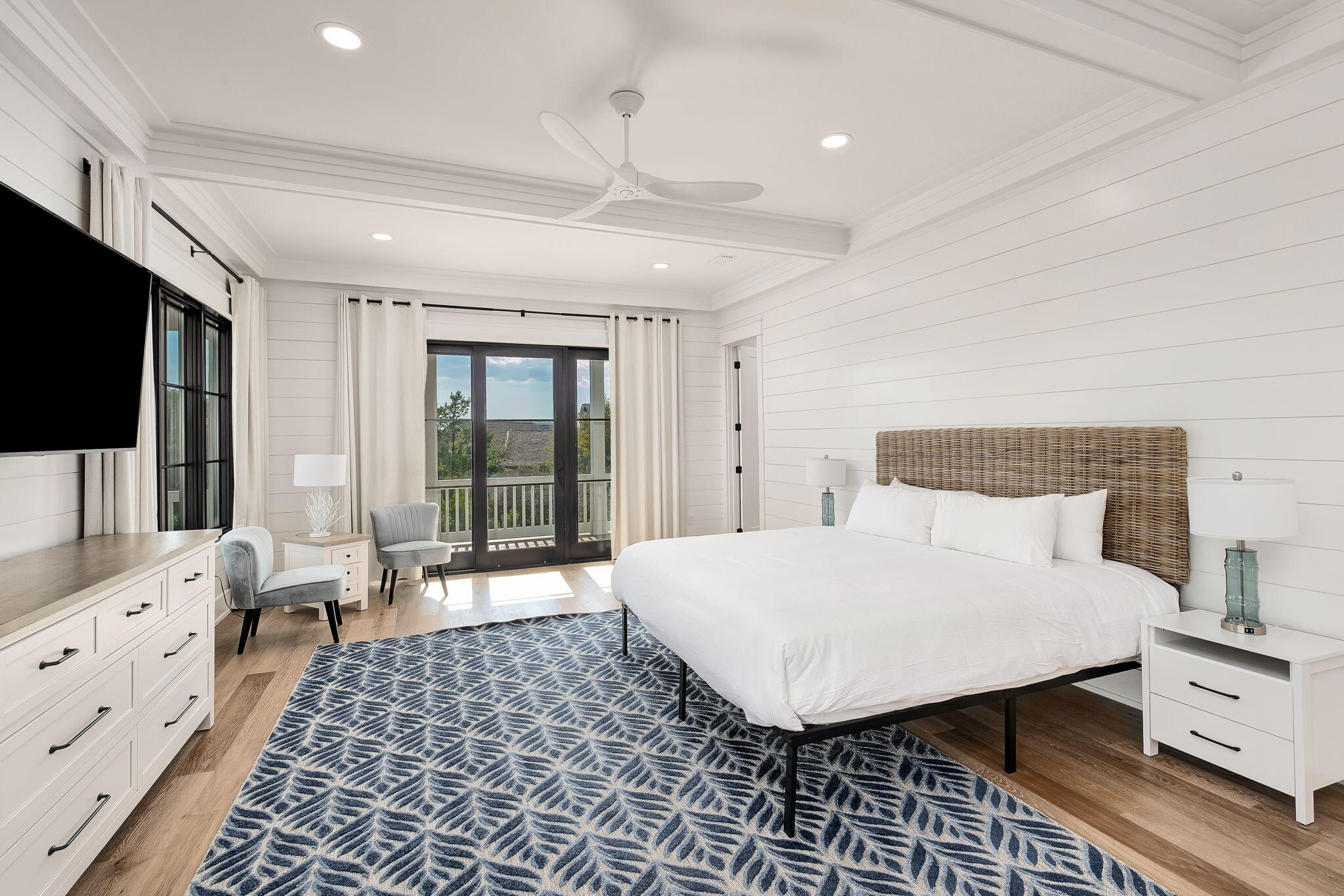 7570 East County Highway 30A Watersound, FL 32461 - Photo 39 of 64 a large bedroom with a bed and flat tv screen on the dresser