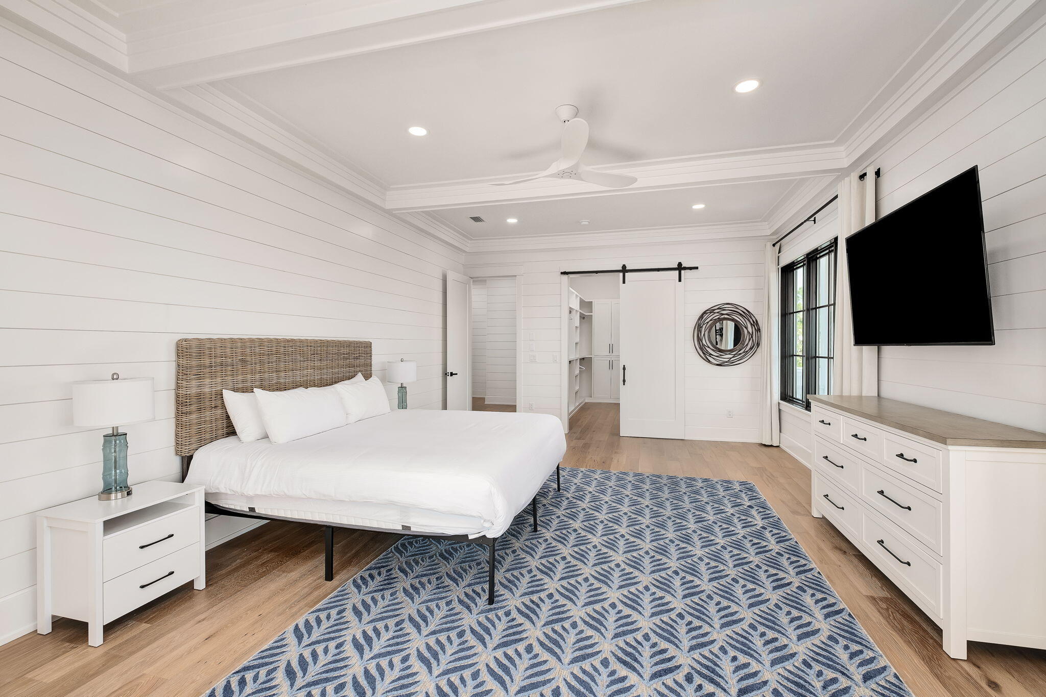 7570 East County Highway 30A Watersound, FL 32461 - Photo 40 of 64 a spacious bedroom with a bed and a flat screen tv