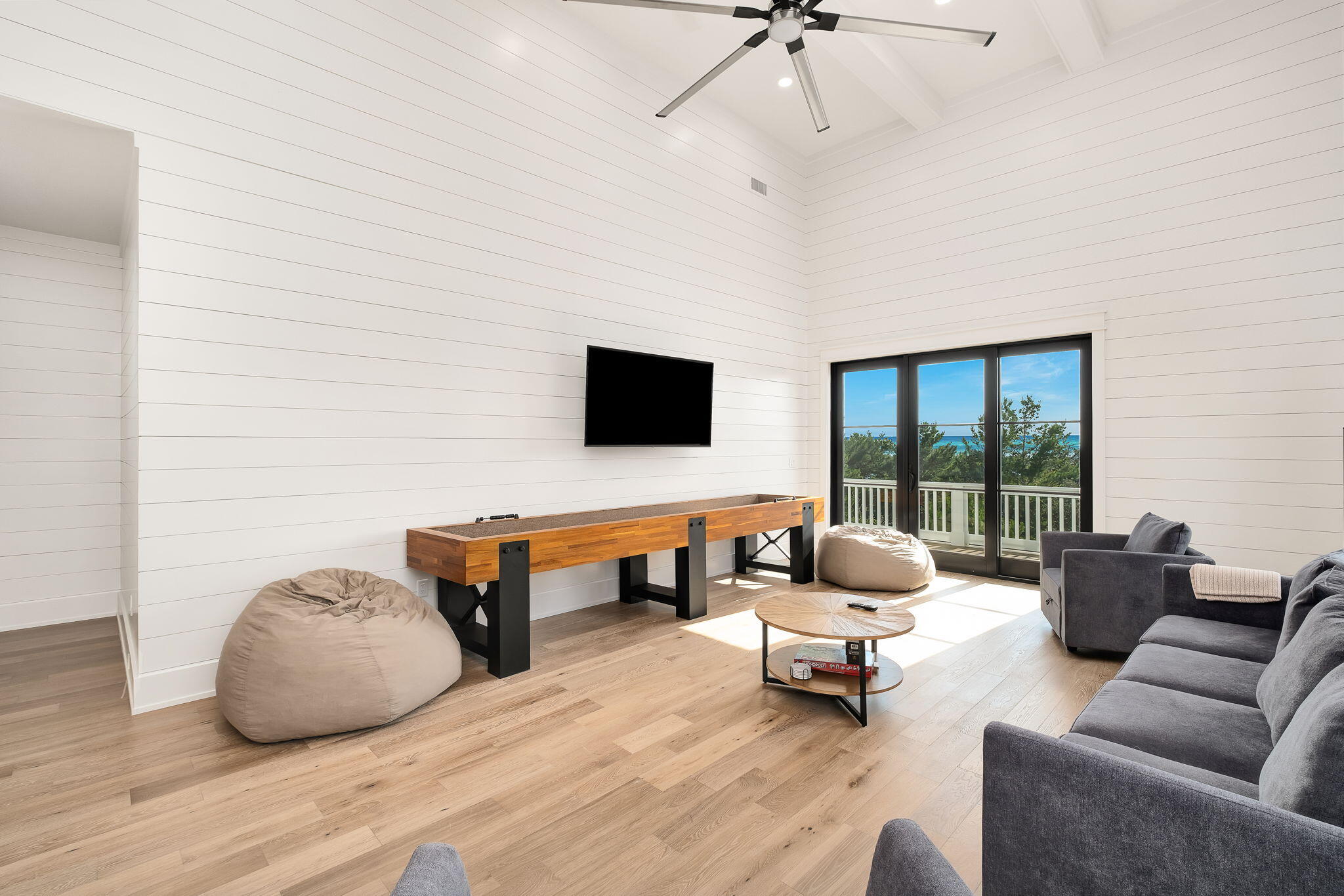 7570 East County Highway 30A Watersound, FL 32461 - Photo 45 of 64 a living room with furniture and a flat screen tv
