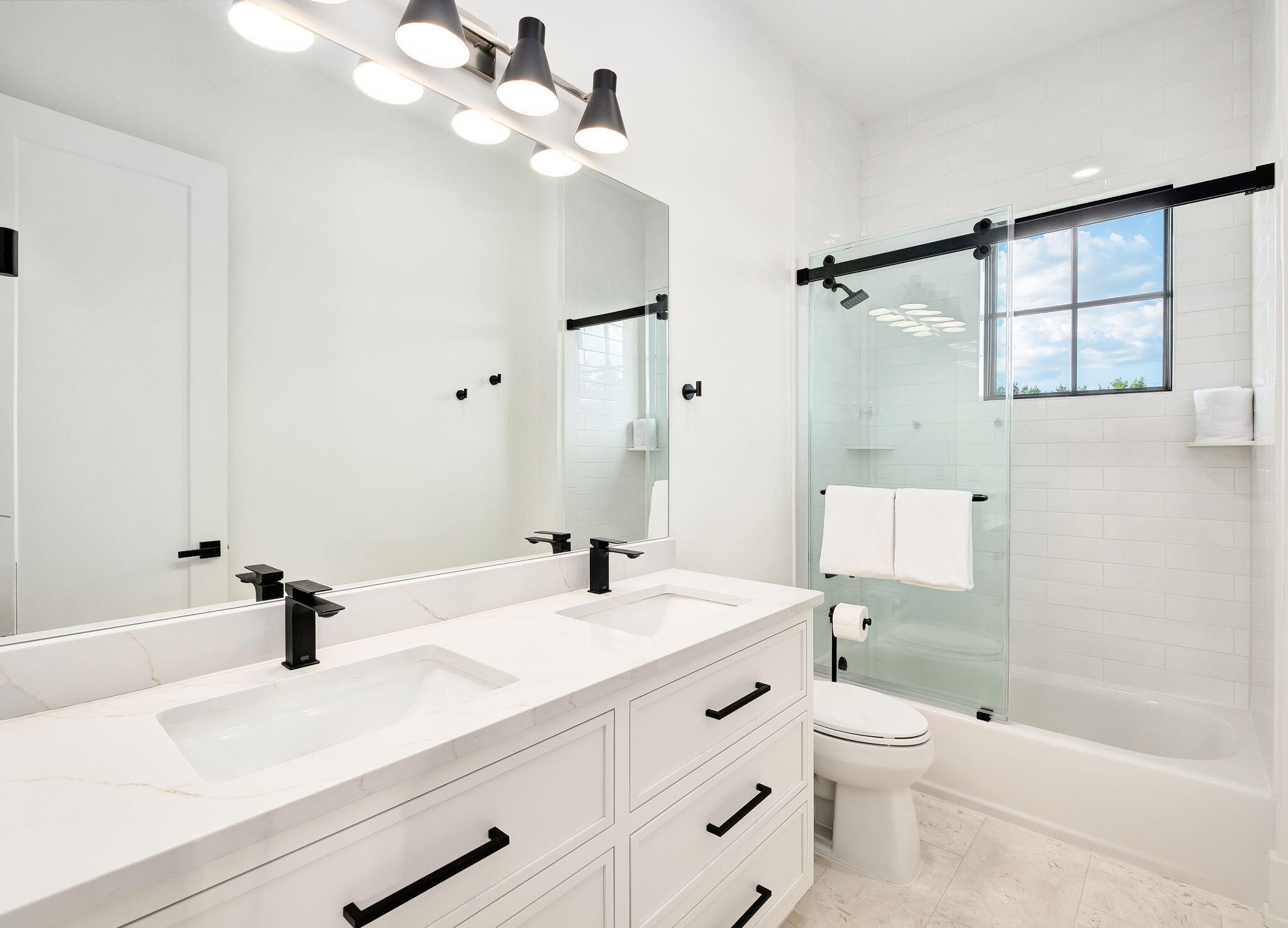 7570 East County Highway 30A Watersound, FL 32461 - Photo 48 of 64 a bathroom with a sink a toilet and a mirror