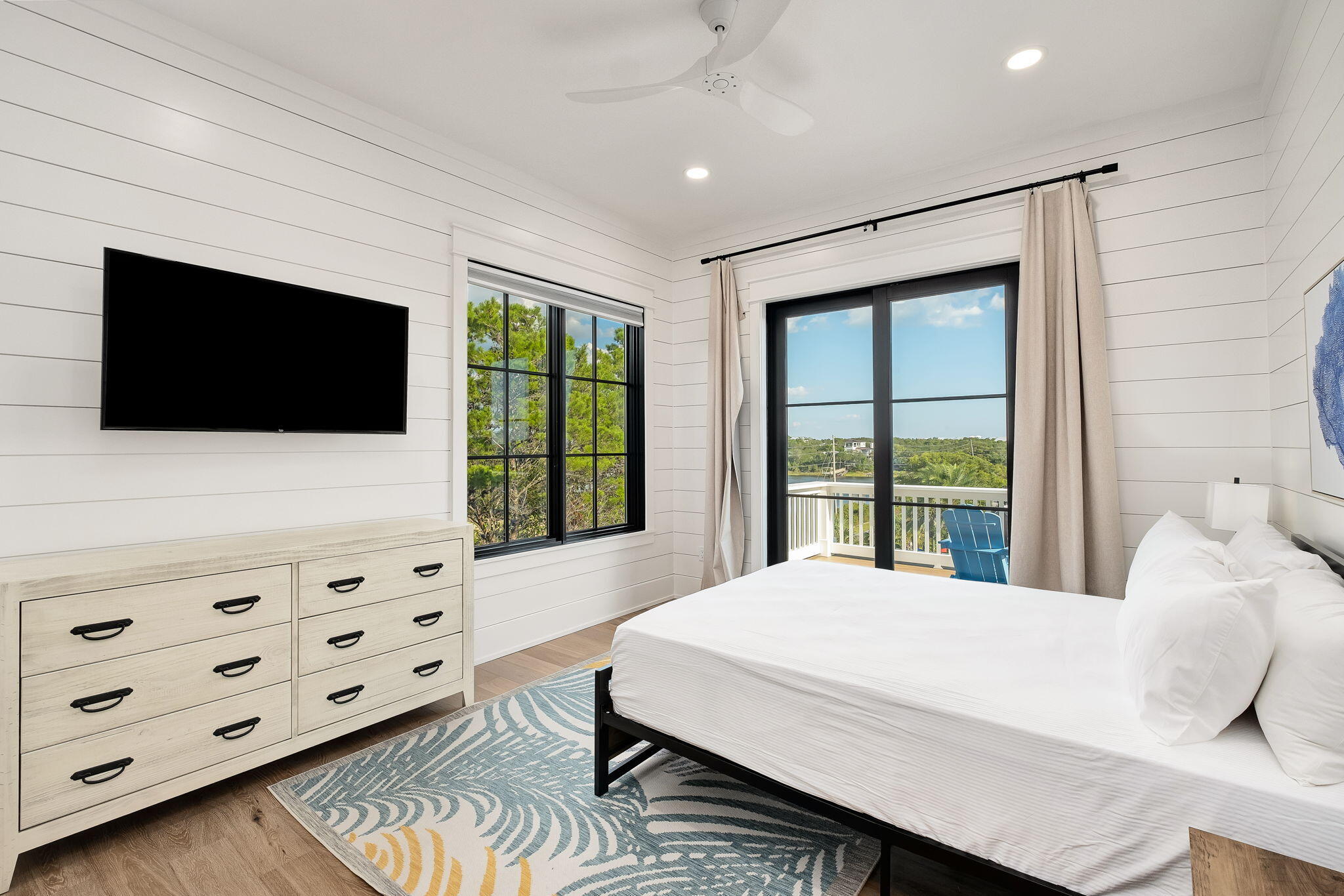 7570 East County Highway 30A Watersound, FL 32461 - Photo 50 of 64 a bedroom with a bed a flat tv screen and a dresser