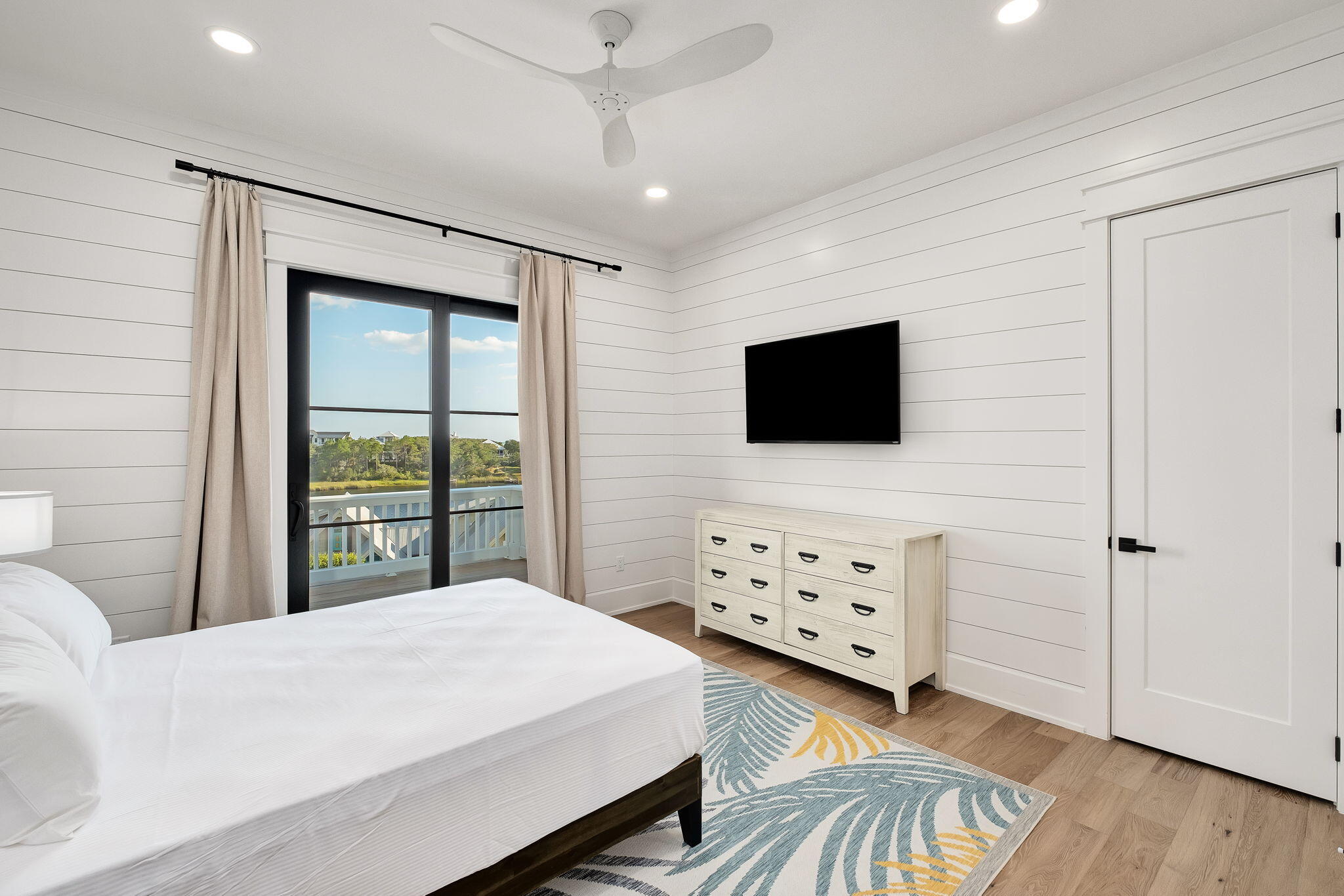 7570 East County Highway 30A Watersound, FL 32461 - Photo 53 of 64 a bedroom with a bed and a flat screen tv