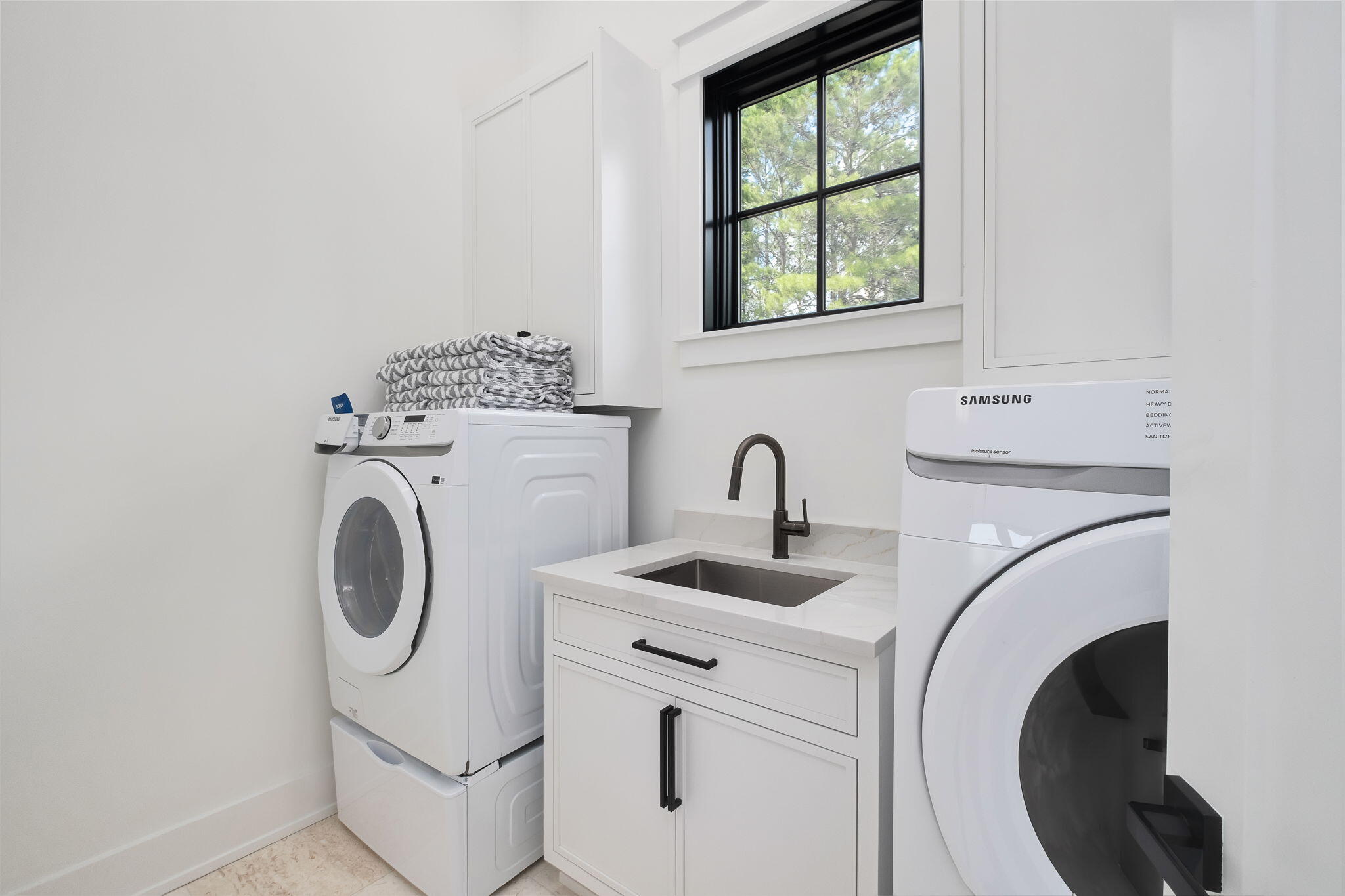7570 East County Highway 30A Watersound, FL 32461 - Photo 56 of 64 a utility room with sink dryer and washer