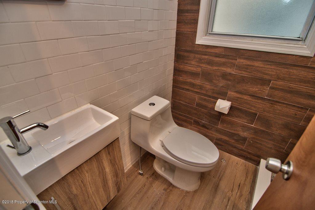 1324 Linden Street Scranton, PA 18510 - Photo 13 of 28 a white toilet sitting next to a small bathroom