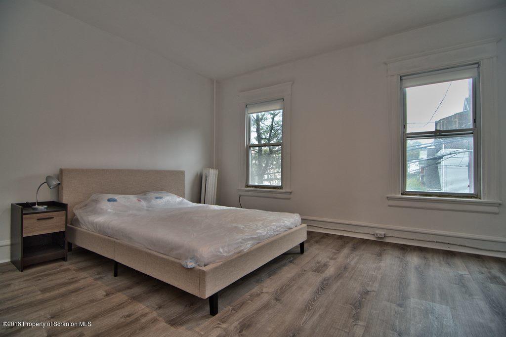 1324 Linden Street Scranton, PA 18510 - Photo 16 of 28 a bedroom with a bed window and wooden floor