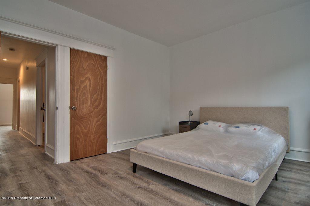 1324 Linden Street Scranton, PA 18510 - Photo 17 of 28 a bedroom with a bed and wooden floor
