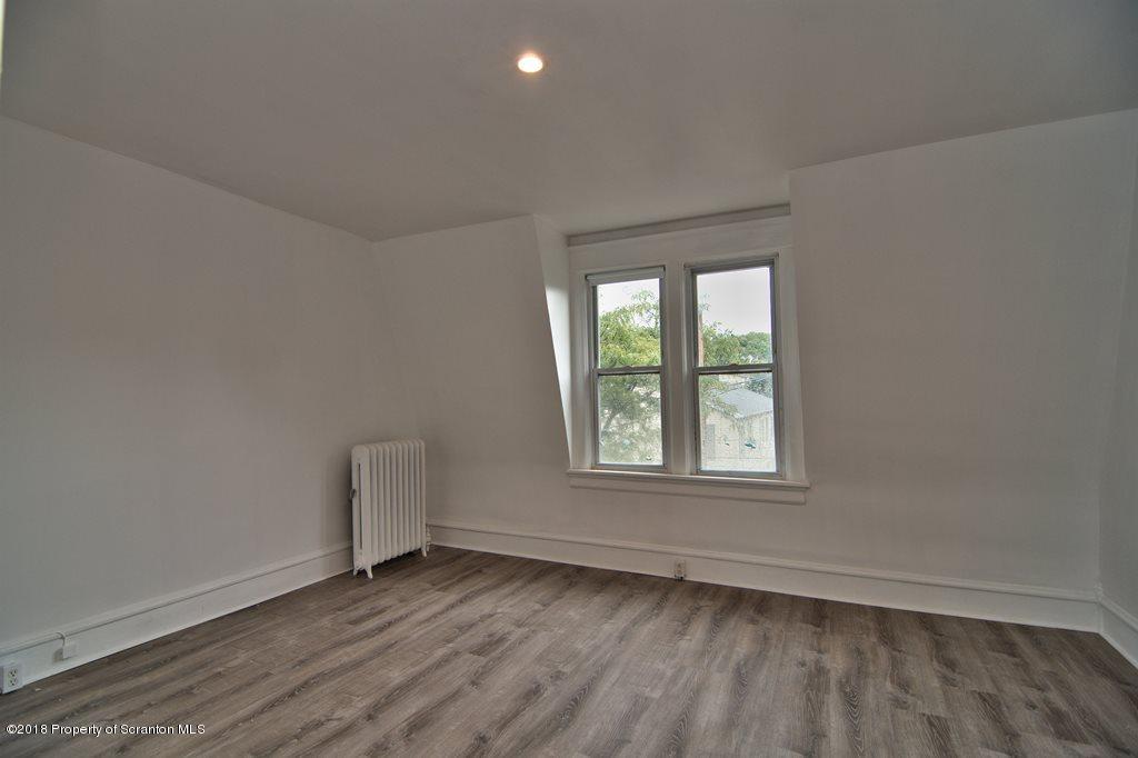 1324 Linden Street Scranton, PA 18510 - Photo 23 of 28 an empty room with wooden floor and windows