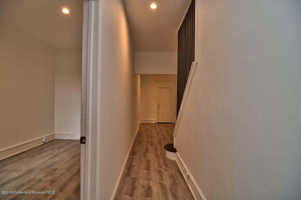 1324 Linden Street Scranton, PA 18510 - Photo 5 of 28 a view of a hallway with wooden floor and staircase