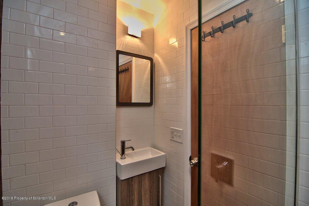 1324 Linden Street Scranton, PA 18510 - Photo 8 of 28 a bathroom with a shower a sink and mirror