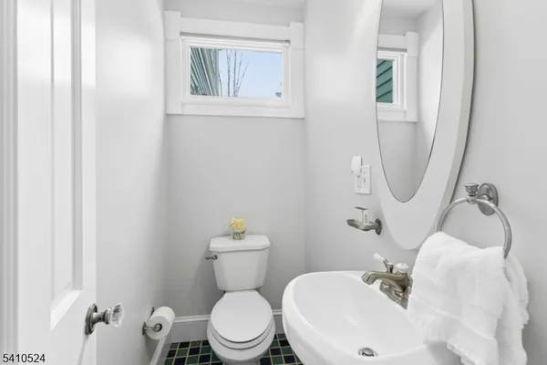 a white toilet sitting next to a bathroom sink