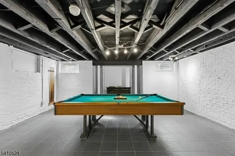 a bathroom with a granite countertop sink a mirror and a shower