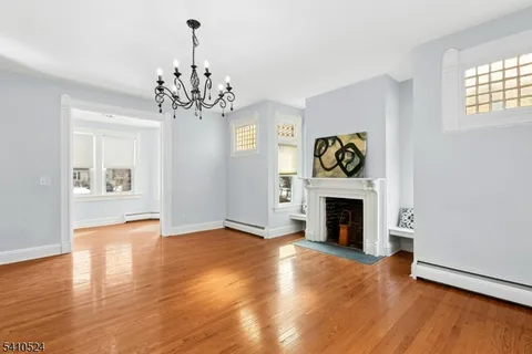 a view of an empty room with window and fire place