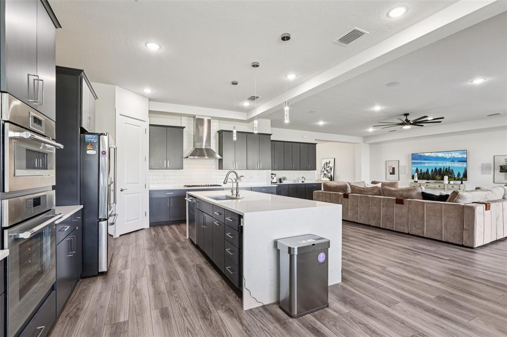 8743 Sanders Tree Loop Wesley Chapel, FL 33545 - Photo 11 of 41 a large kitchen with stainless steel appliances lots of counter top space