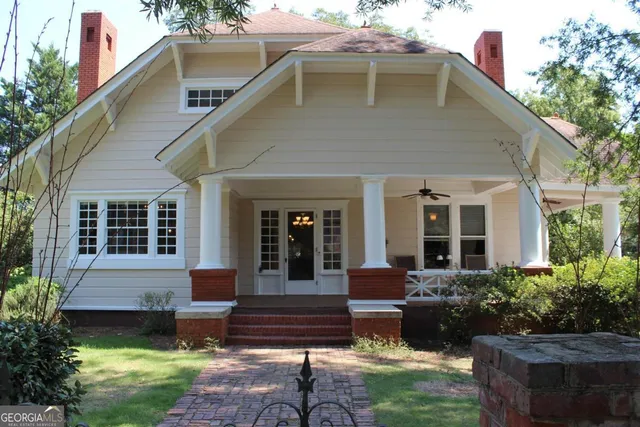 a view of a house with backyard sitting area and garden