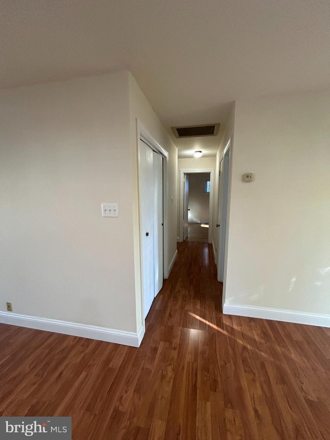 7511 Hamlet Street Springfield, VA 22151 - Photo 15 of 40 a view of a hallway with wooden floor