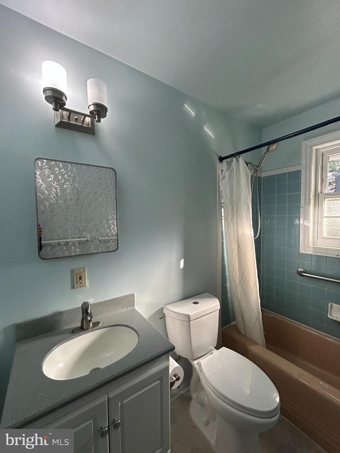 7511 Hamlet Street Springfield, VA 22151 - Photo 19 of 40 a bathroom with a sink a toilet a mirror and shower