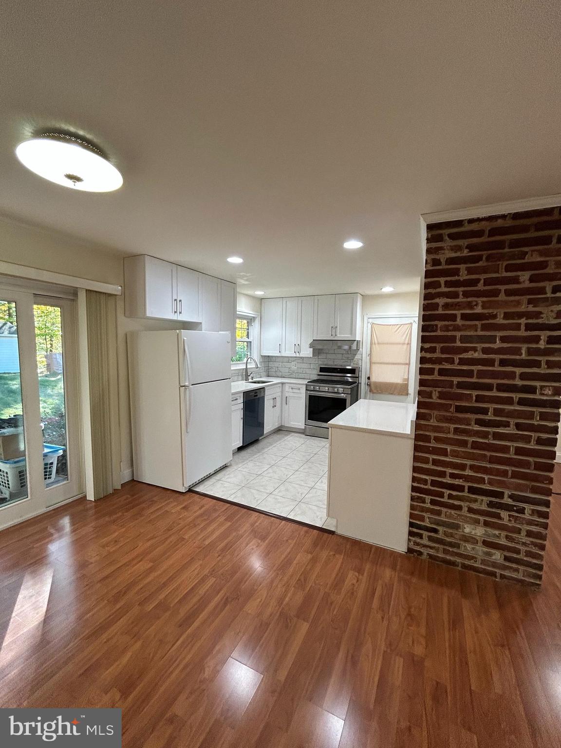 7511 Hamlet Street Springfield, VA 22151 - Photo 22 of 40 a kitchen with stainless steel appliances a refrigerator and a stove top oven