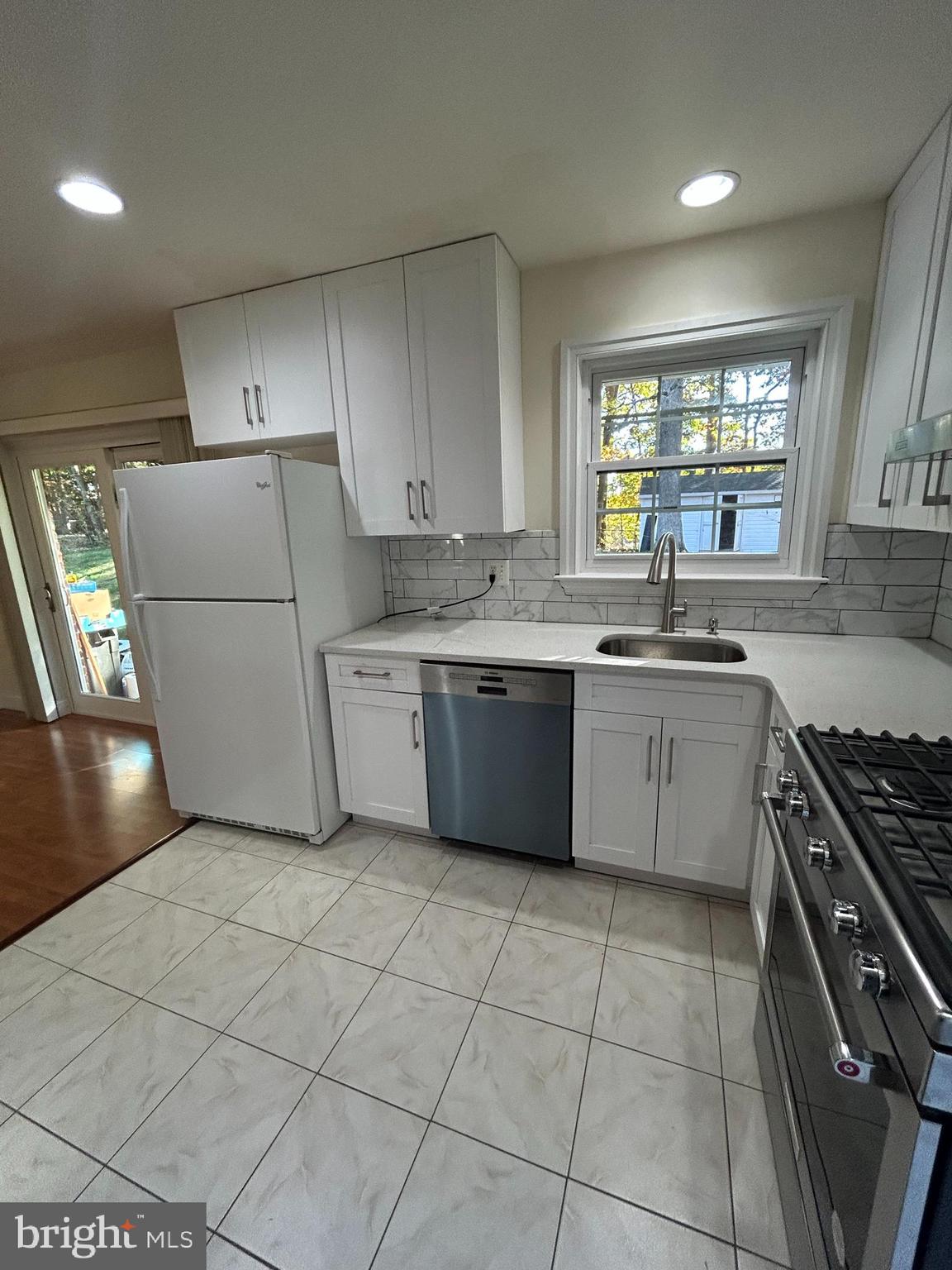 7511 Hamlet Street Springfield, VA 22151 - Photo 25 of 40 a kitchen with a sink a stove a refrigerator and cabinets