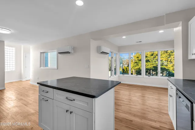 a kitchen with granite countertop a stove a sink and a refrigerator
