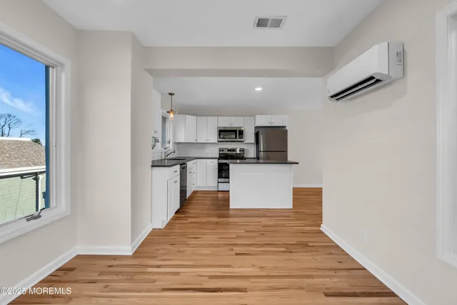 a view of kitchen with microwave and cabinets
