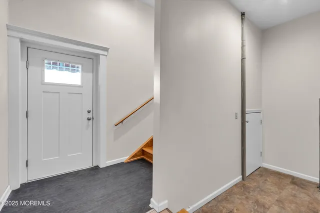 a view of an entryway with wooden floor