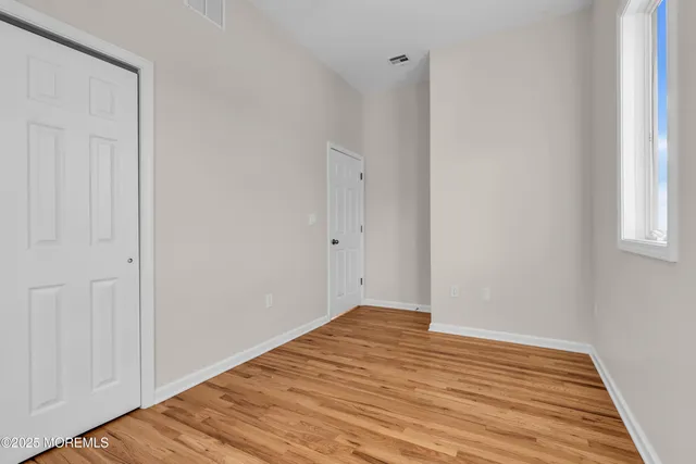 a view of a room with wooden floor
