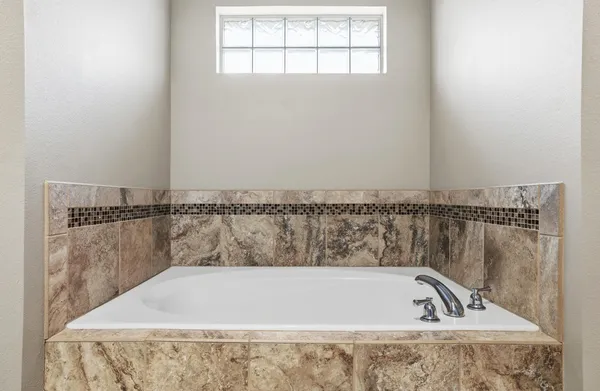 a bath tub sitting next to a window