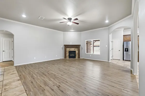 a view of an empty room with a fireplace and a window