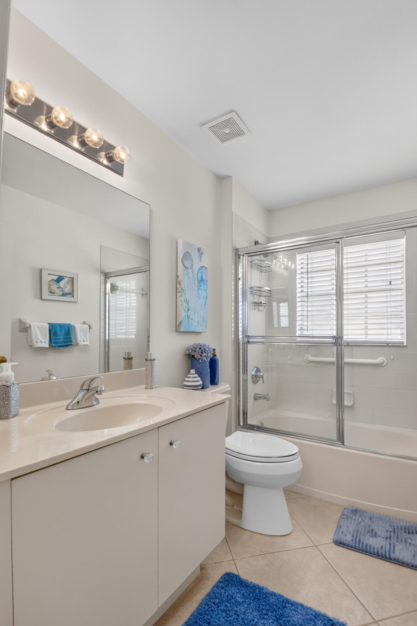 15340 Floral Club Road Delray Beach, FL 33484 - Photo 31 of 42 a bathroom with a double vanity sink a toilet a mirror and a shower
