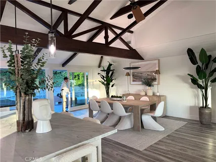 a living room with lots of furniture and wooden floors