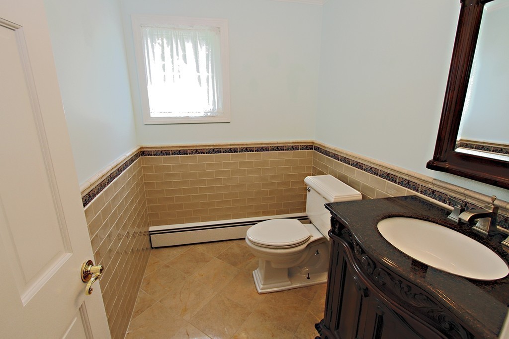 99 Parmenter Road Framingham, MA 01701 - Photo 11 of 30 a bathroom with a sink a toilet and a mirror