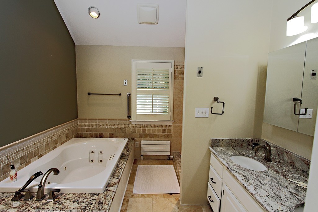 99 Parmenter Road Framingham, MA 01701 - Photo 15 of 30 a bathroom with a tub sink and mirror