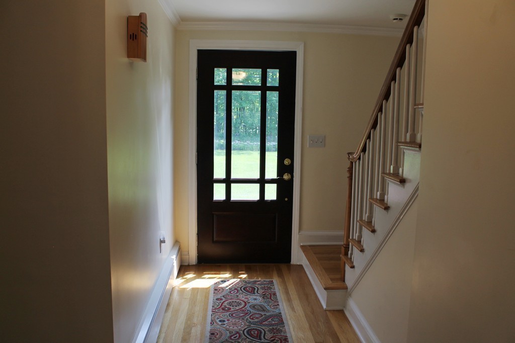 99 Parmenter Road Framingham, MA 01701 - Photo 4 of 30 a view of entryway with wooden floor and stairs