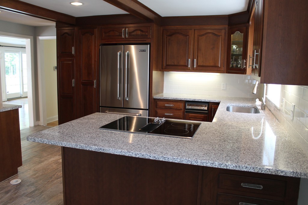99 Parmenter Road Framingham, MA 01701 - Photo 7 of 30 a kitchen with granite countertop stainless steel appliances and wooden cabinets
