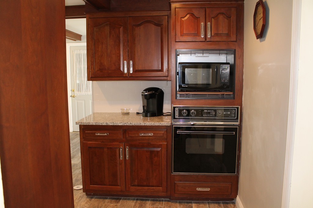 99 Parmenter Road Framingham, MA 01701 - Photo 8 of 30 a kitchen with granite countertop wood cabinets and stainless steel appliances