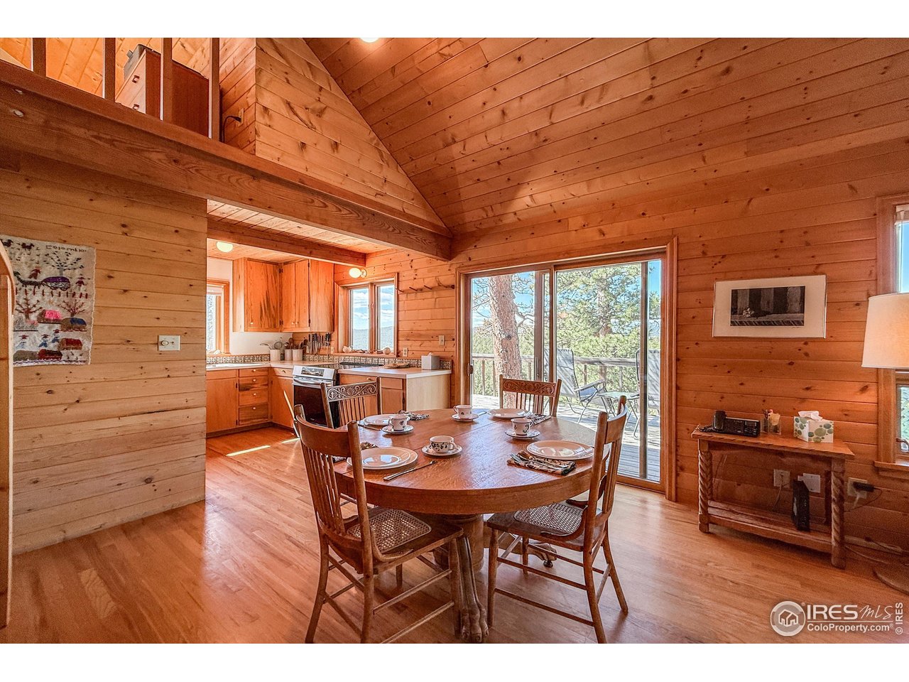 18673 Highway 7 Lyons, CO 80540 - Photo 21 of 39 Dining room open to kitchen and living room and that magical deck