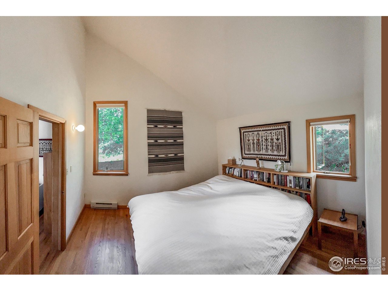 18673 Highway 7 Lyons, CO 80540 - Photo 33 of 39 Primary bedroom enjoys high vaulted ceilings and views to the west