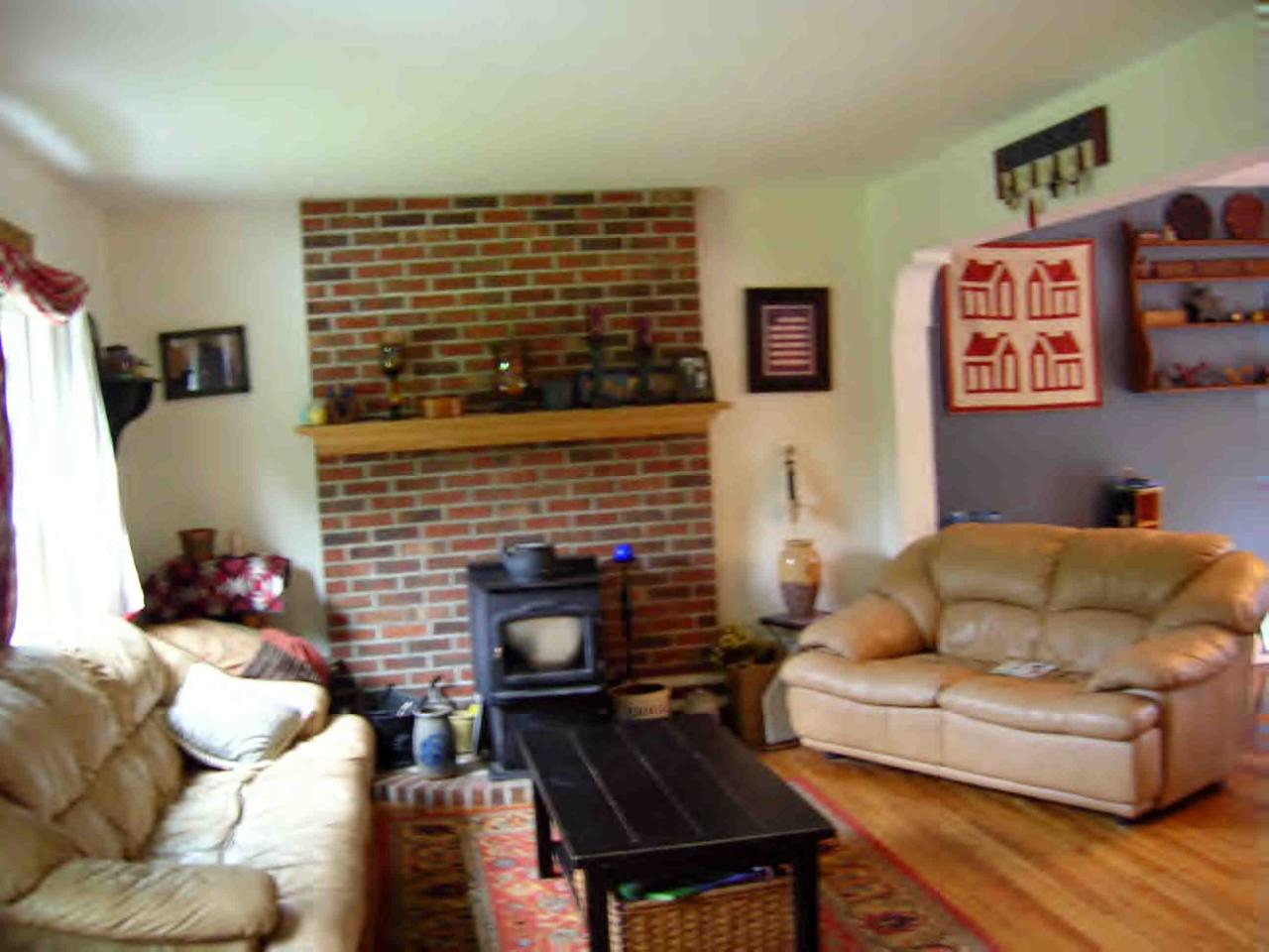 94 Morse Road Becket, MA 01223 - Photo 2 of 4 a living room with furniture and a fireplace