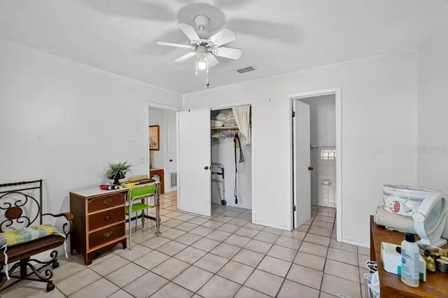 a bathroom with a granite countertop toilet sink and mirror