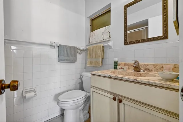 a bathroom with a glass shower door and a vanity
