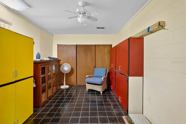a kitchen with a refrigerator a stove top oven and a dining table