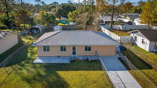 an aerial view of residential houses with outdoor space