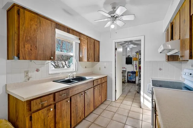a kitchen with stainless steel appliances a sink stove and cabinets