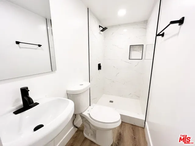 a bathroom with a sink toilet and shower