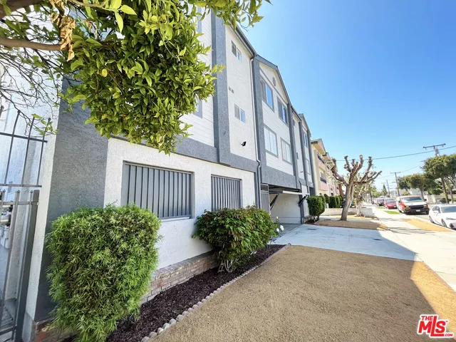 a view of a street with potted plants