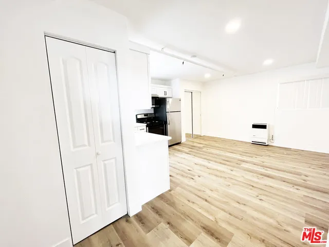 a large kitchen with cabinets and stainless steel appliances