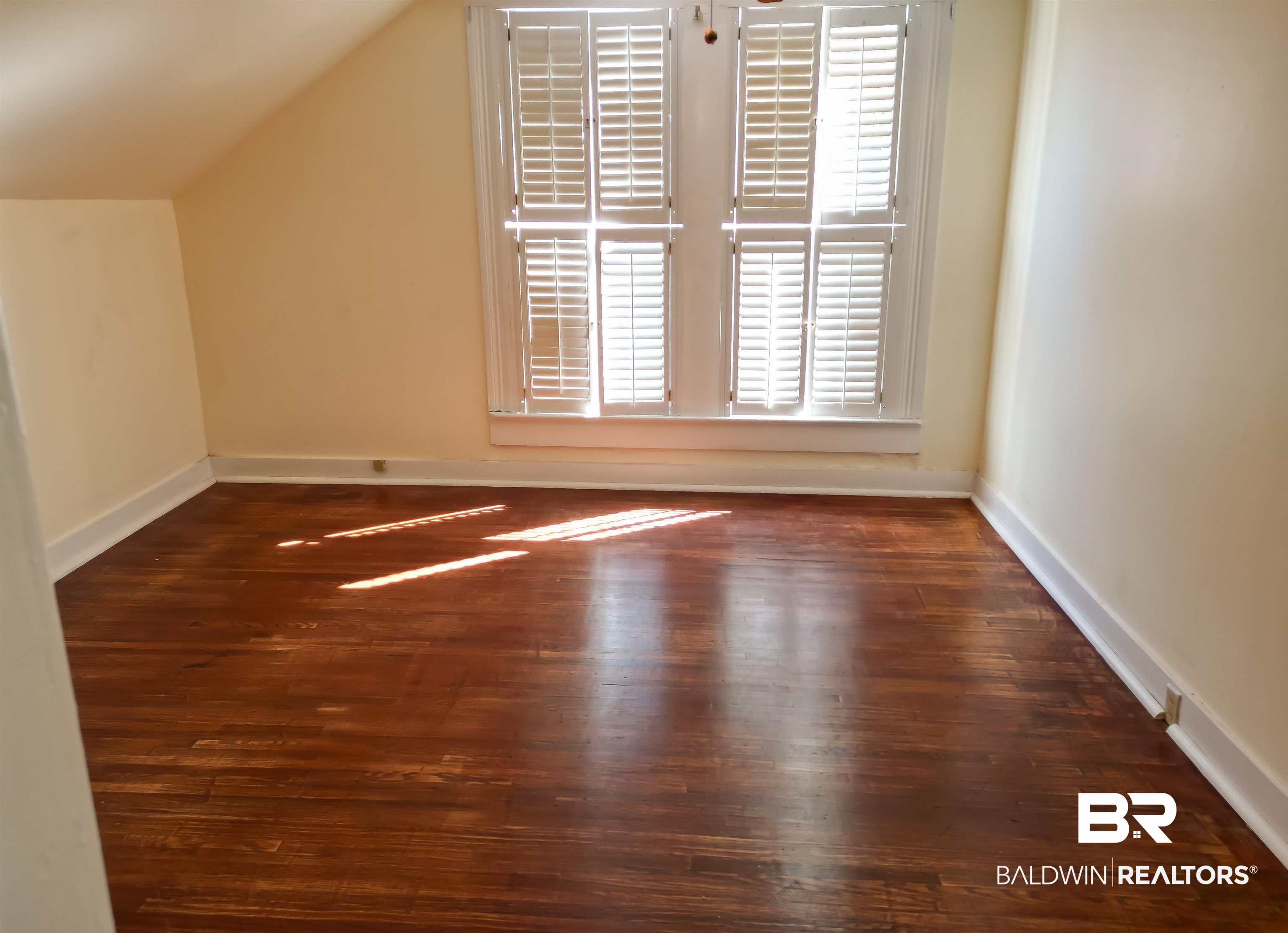 73 Liberty Street Monroeville, AL 36460 - Photo 19 of 29 Additional living space with dark wood-type flooring and vaulted ceiling