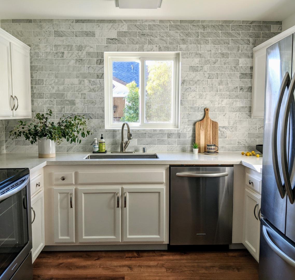 a kitchen with a sink stove and refrigerator